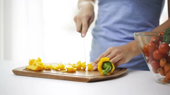 Close Up Of Young Woman Chopping Pepper At Home 2