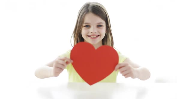 Smiling Girl With Red Heart At Home