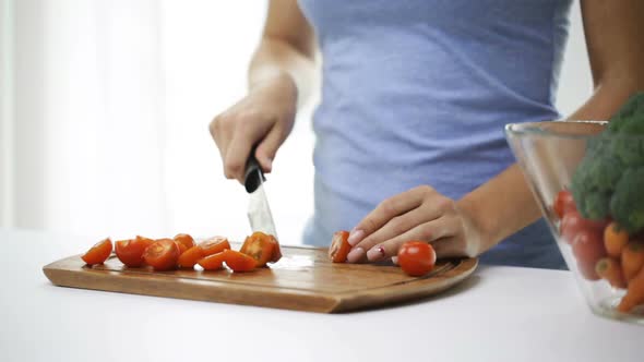 Close Up Of Young Woman Chopping Tomatoes At Home 2