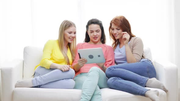 Two Smiling Teenage Girls With Tablet Pc At Home 1