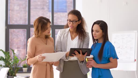 Businesswomen with Tablet Pc and Papers at Office