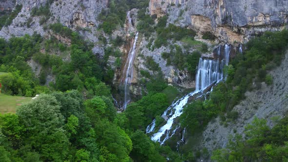 aerial drone view Ujevara E Sotires wild waterfalls in Nivica Canyon with cliffs of karst gorge with