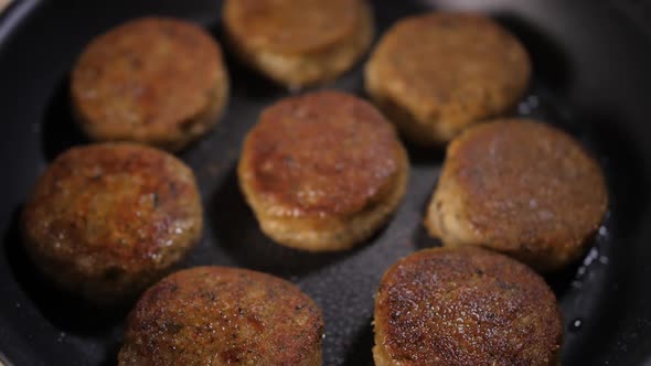 Frying Meatballs in Frying Pan Sizzling in Hot Oil