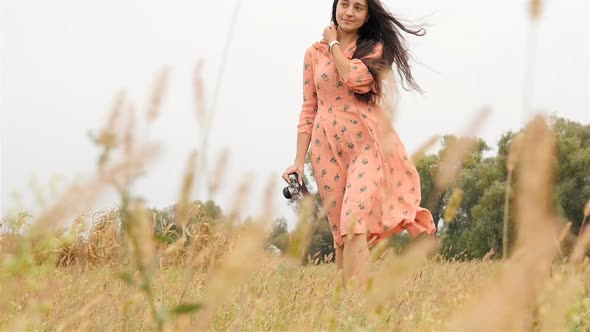 A Girl with a Camera is on the Field