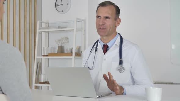 Doctor Talking with Patient in Clinic