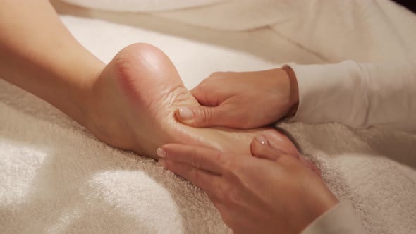 Young, healthy and beautiful woman gets massage therapy in the spa salon.