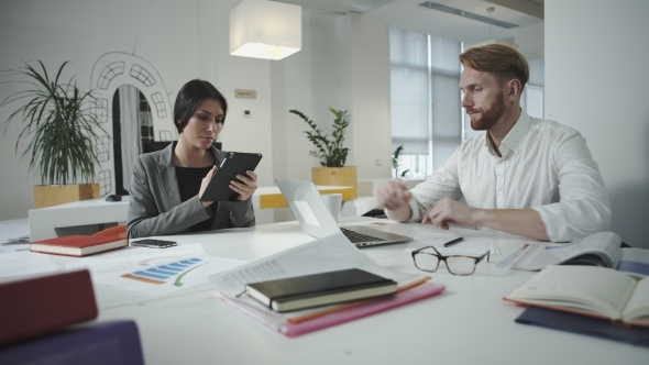 Man and Woman Working In The Office