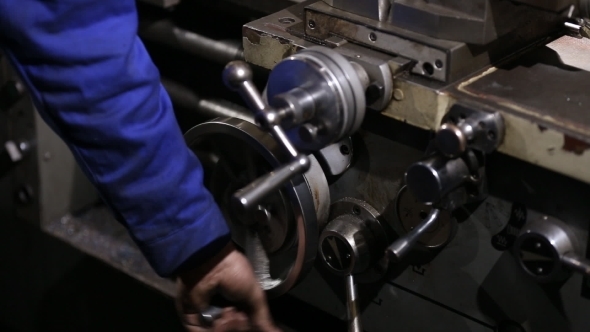 Operator Turns The Handle To Move The Cutter