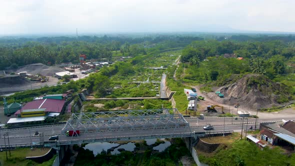 Kali Putih River bridge and dry riverbed overgrown by greenery aerial view