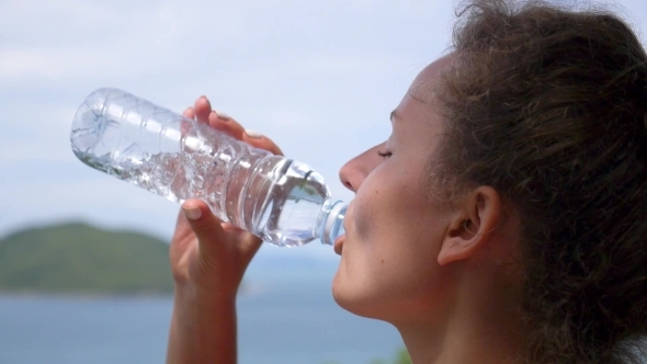 Woman Drinking Water From Bottle