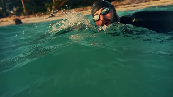 Professional Swimmer Training For Triathlon Competition In Open Water. Swimmer Underwater Workout.