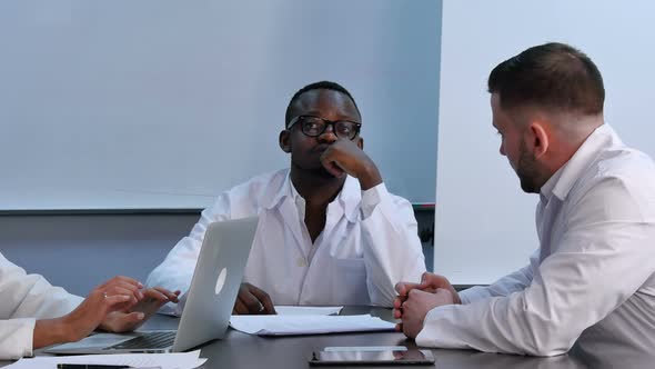 Multiracial Group of Doctors Having Discussion in Office