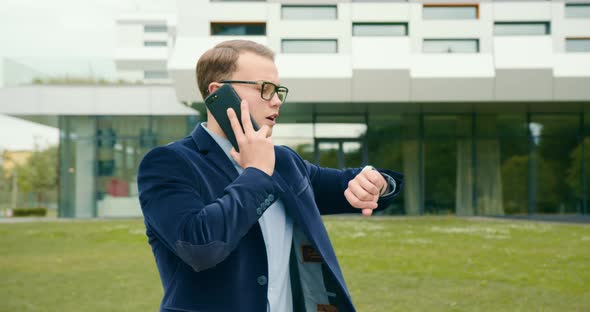 The Businessman is Going and Talking Emotionally on the Phone