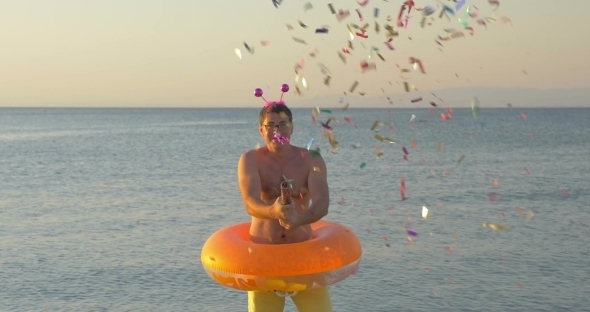 Man With Confetti Cracker At The Seaside