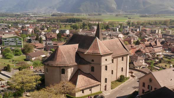 Flying away from beautiful old church in small Swiss town