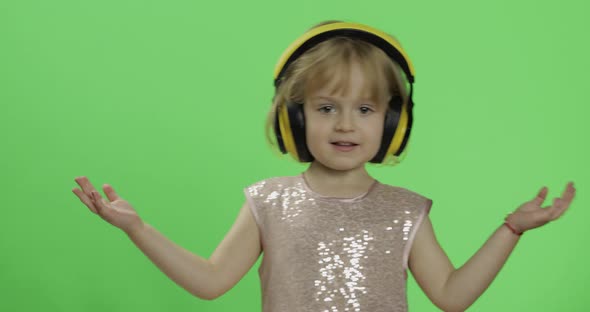 Girl in Glossy Dress and Headphone Listening To Music and Dancing. Chroma Key