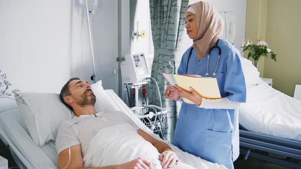 Female doctor talking with patient in hospital bed 4k