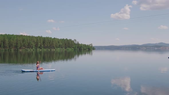 Scenery of Woman Paddling in Sea