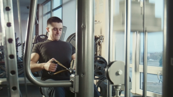 The Guy Is Engaged In a Gym On The Exercise alt