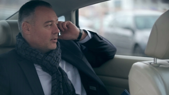 Businessman Talking On The Phone In The Car