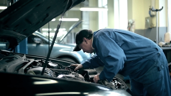 Mechanic Inspecting The Car Engine alt