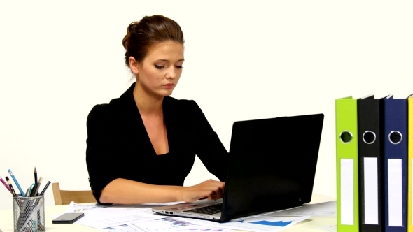 Businesswoman In Office Using Laptop 