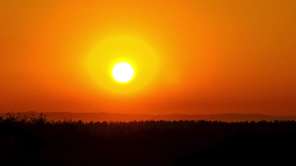 Timelapse Sunset in the Sky Big Bright Yellow Sun Moves Down on the Horizon