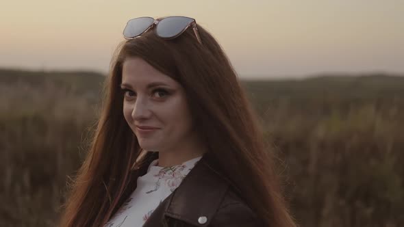 Beautiful Carefree Woman Enjoying Nature. Looking at Camera. Young Woman Walking