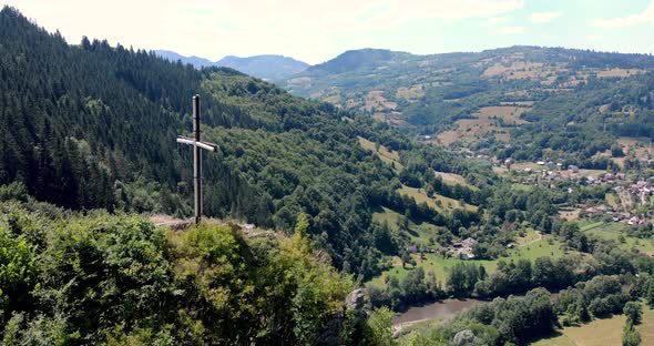 Aries River At The Valley Of Apuseni Mountains With A View Of A Small Village