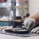 Repairman Wipes Processor of Graphics Chipset Putting Thermal Paste at Workshop - VideoHive Item for Sale