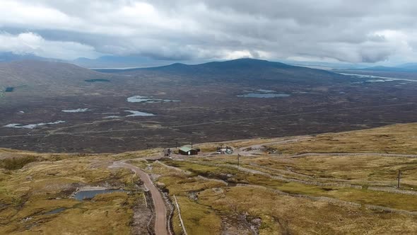 Cinematic drone tilting shot of cloudy highland mountains