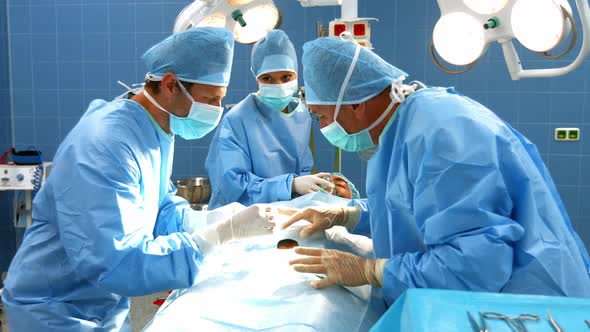 Surgeons performing operation in operation room