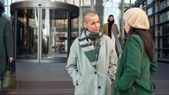 Female Coworkers Enjoying Conversation Outside the Workplace in Winter
