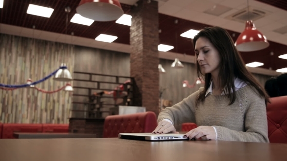 Woman Comes, Opens The Laptop And Starts Working