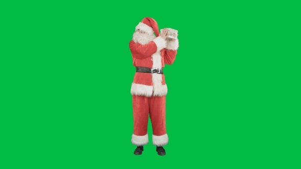 Happy Santa Claus Carrying Gifts On a Green Screen alt
