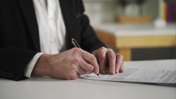 Businessman Signs Documents alt