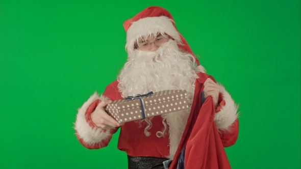 Santa Claus Packaging Gifts On a Green Screen alt