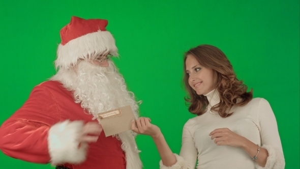 Happy Santa Claus With His Woman Helper Reading