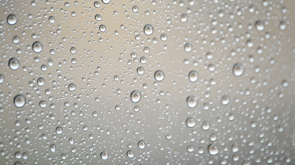Raindrops Sliding Down the Glass Window of a Room alt