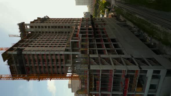 Vertical Aerial Drone Video Construction Site With Cranes