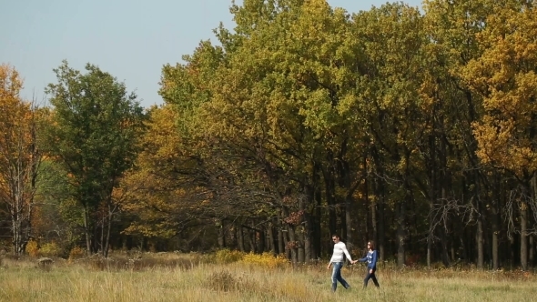 Couple Walking Against Trees