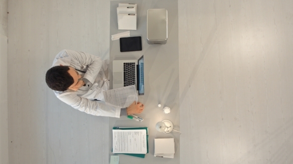 Doctor With a Cellphone And Laptop Computer alt