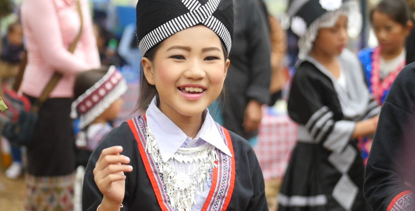 Hmong Young Girl Smiling And Playing A Ball