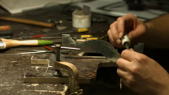 Craftsman Working with Metal Detail.