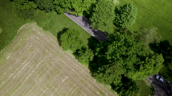 Aerial Top Down Tilt View of Countryside Paved Road and Narrow Trail Rural Path intersection Surroun