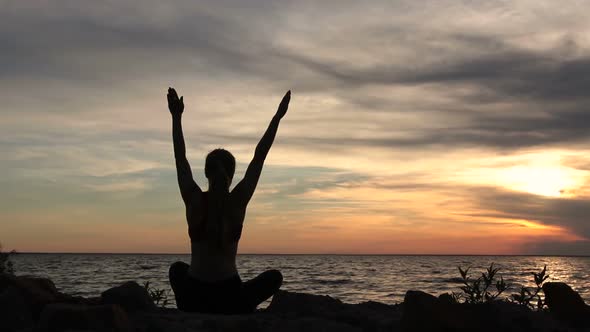 Yoga Woman in Lotus Pose on Beach at Sunset