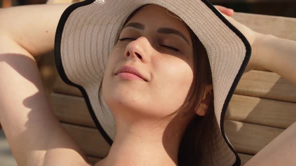 Woman Sunbathing on the Beach