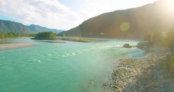 Low Altitude Flight Over Fresh Fast Mountain River with Rocks at Sunny Summer Morning