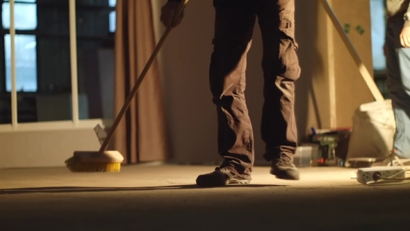 Man Sweeping In Industrial Premises