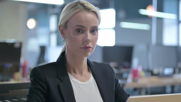 Smiling Young Businesswoman Looking at the Camera